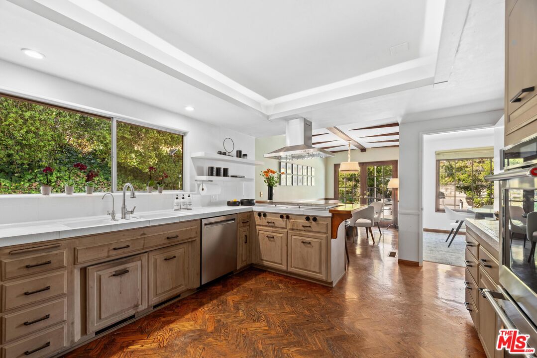 8636 Edwin Drive Los Angeles, CA 90046 - Photo 5 of 25 a large kitchen with stainless steel appliances granite countertop a stove and cabinets