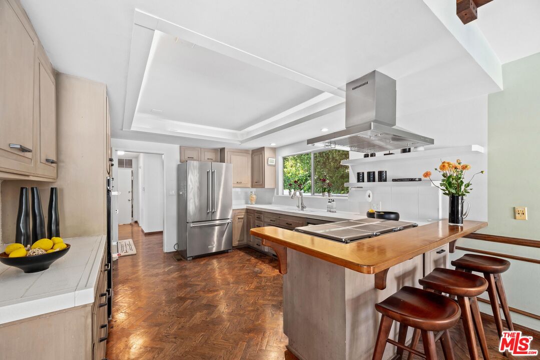 8636 Edwin Drive Los Angeles, CA 90046 - Photo 6 of 25 a kitchen with stainless steel appliances granite countertop a sink a stove and a refrigerator