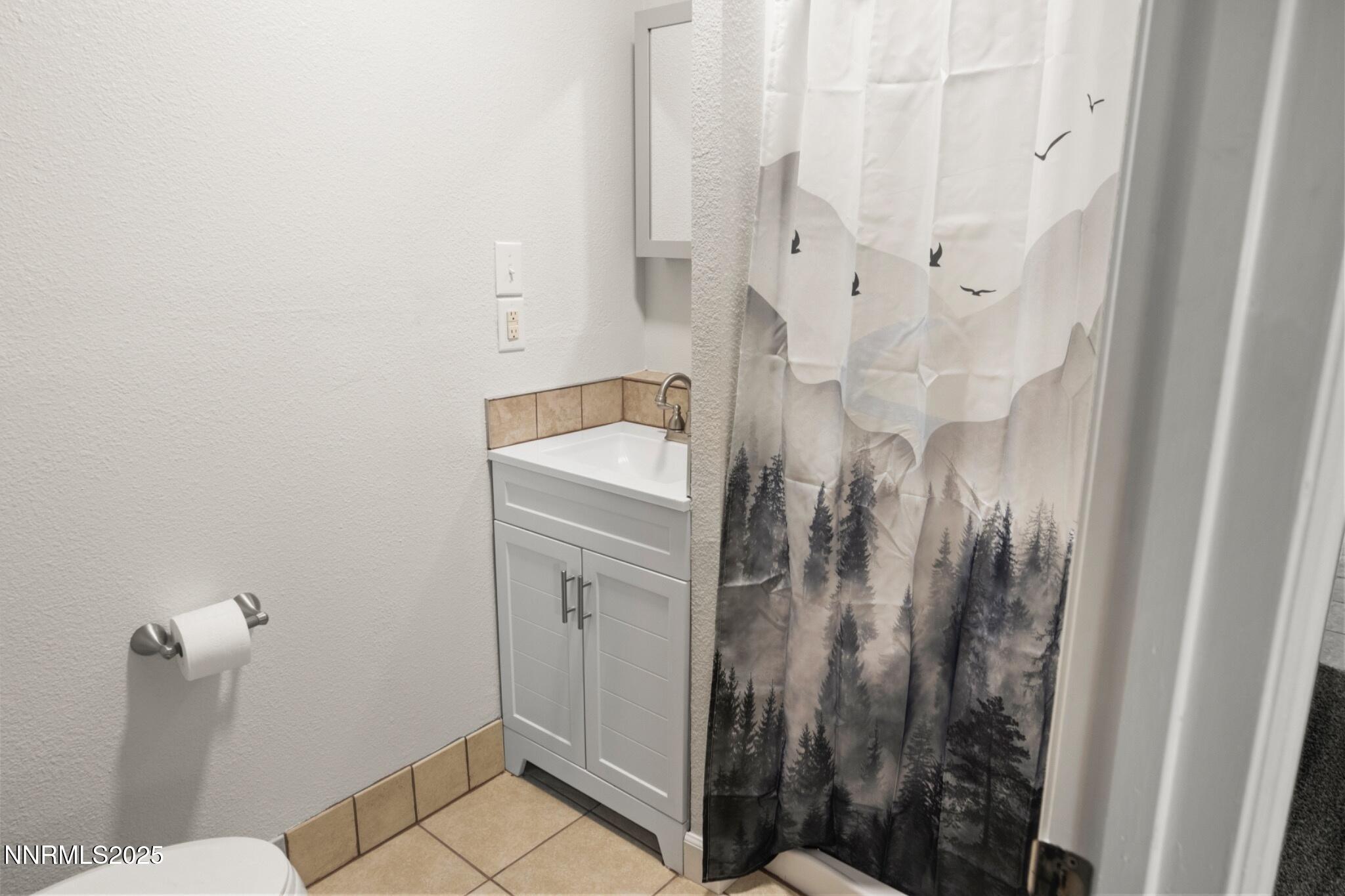 859 B Street Fernley, NV 89408 - Photo 19 of 32 a bathroom with a granite countertop shower and a sink