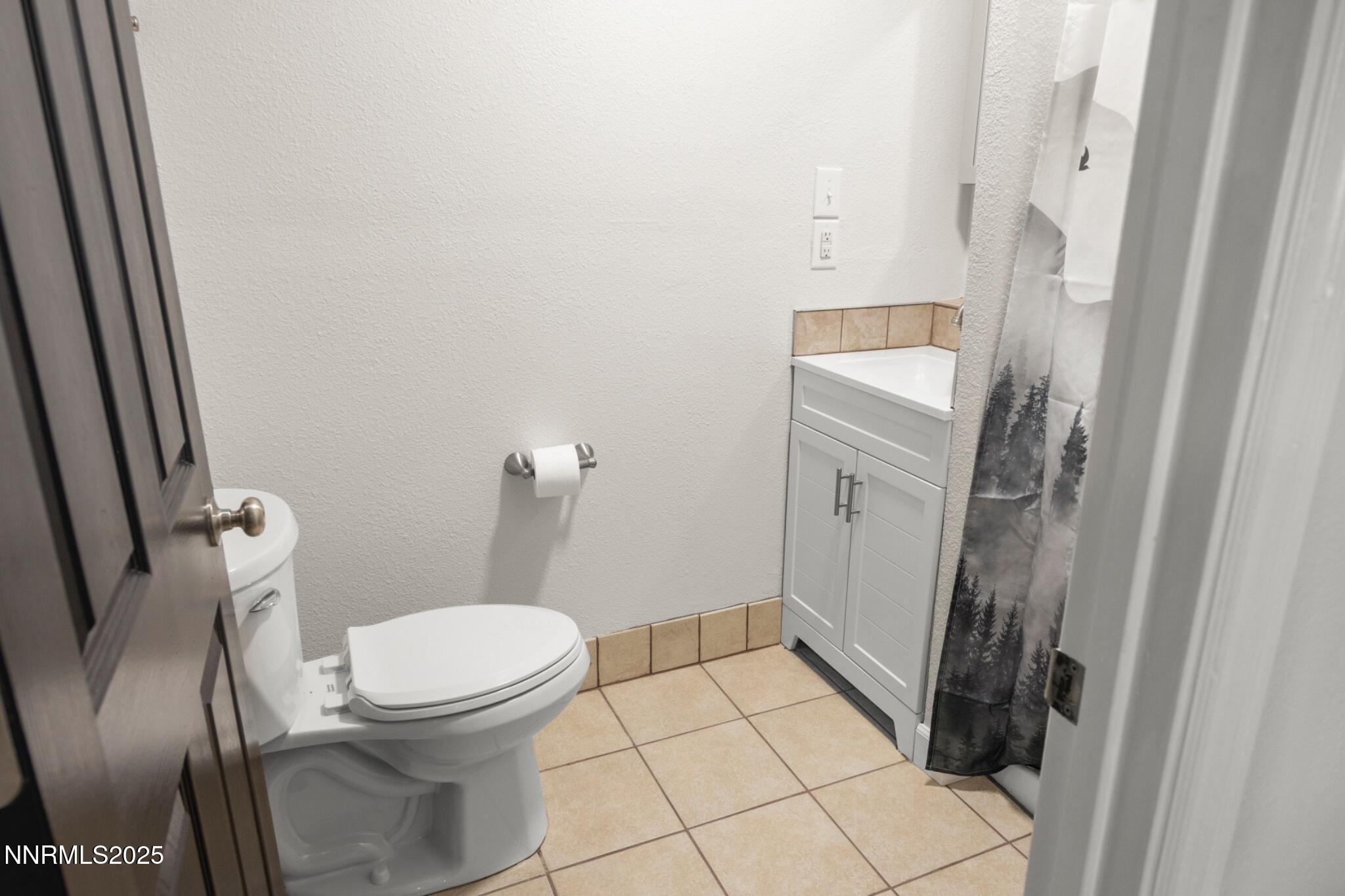 859 B Street Fernley, NV 89408 - Photo 20 of 32 a white toilet sitting next to a white sink and vanity