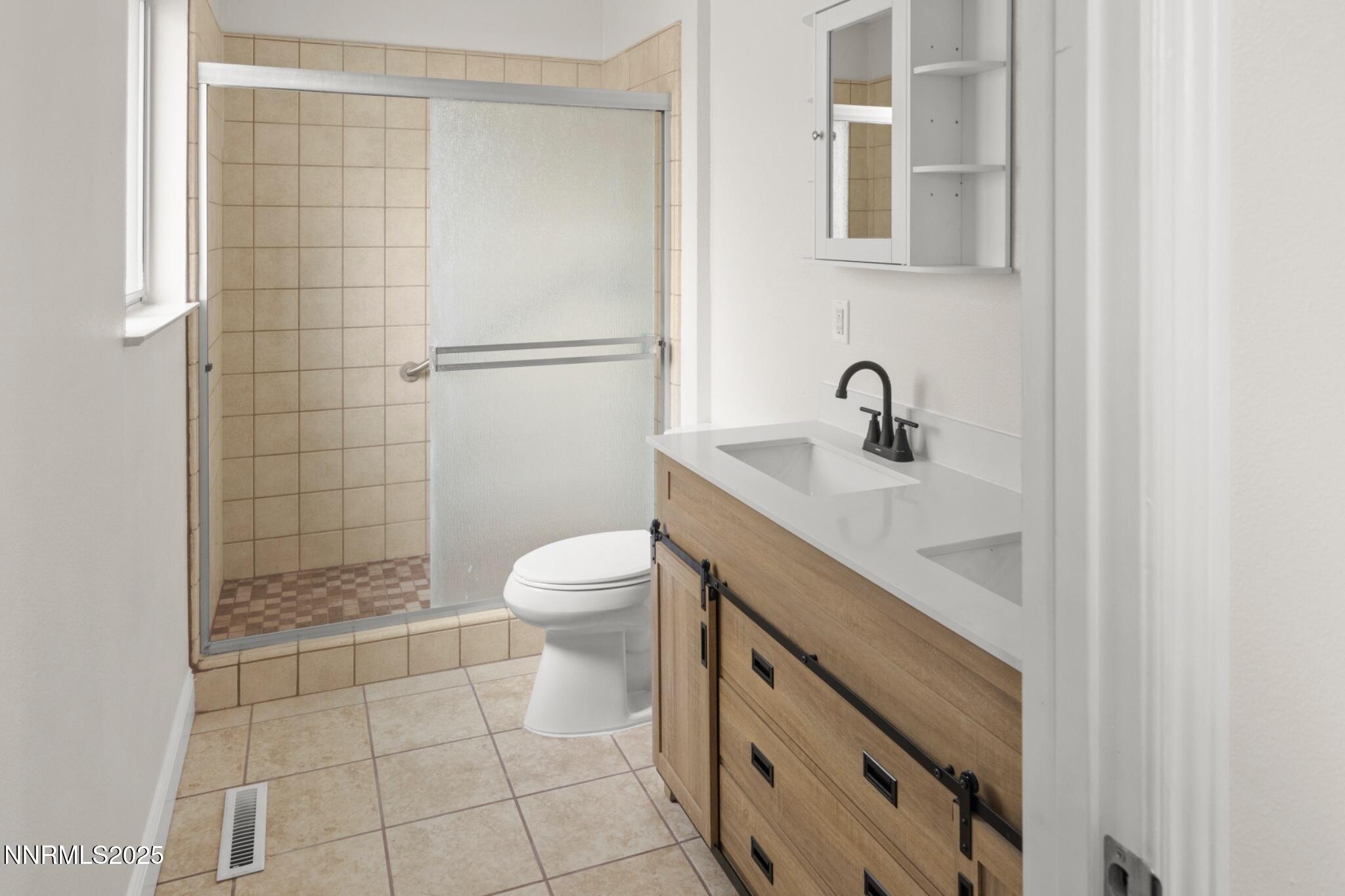 859 B Street Fernley, NV 89408 - Photo 21 of 32 a bathroom with a sink a toilet and shower