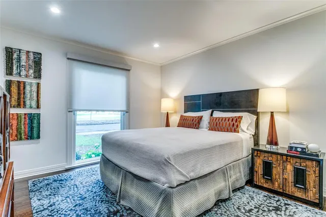 a bedroom with a bed rug and window