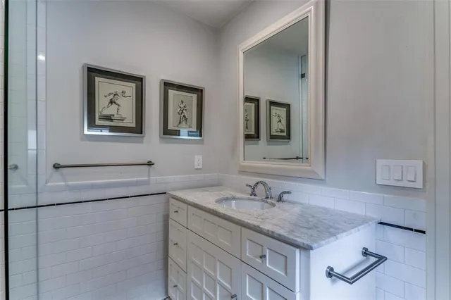a bathroom with a granite countertop sink a mirror and a