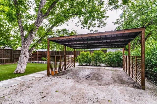 a view of a backyard with a large trees and a small yard