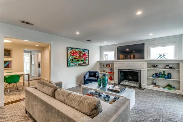 a living room with furniture a flat screen tv and a fireplace