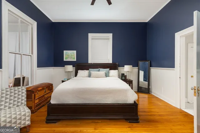 a bedroom with a bed and wooden floor