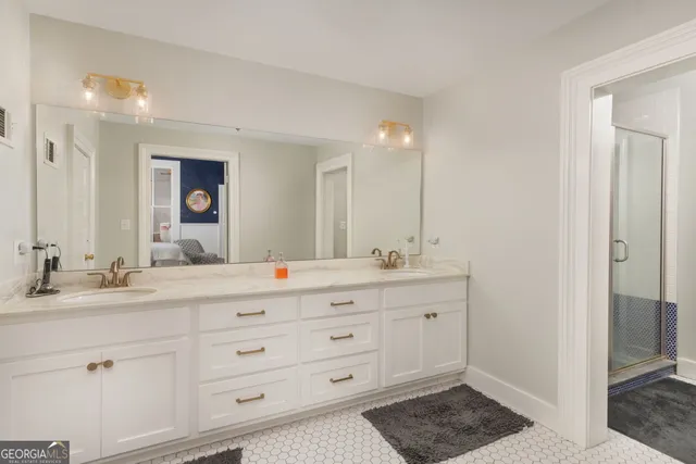 a bathroom with a double vanity sink and a mirror