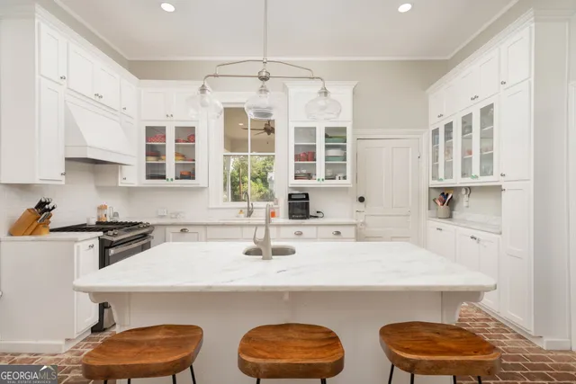a kitchen with stainless steel appliances a sink and a stove