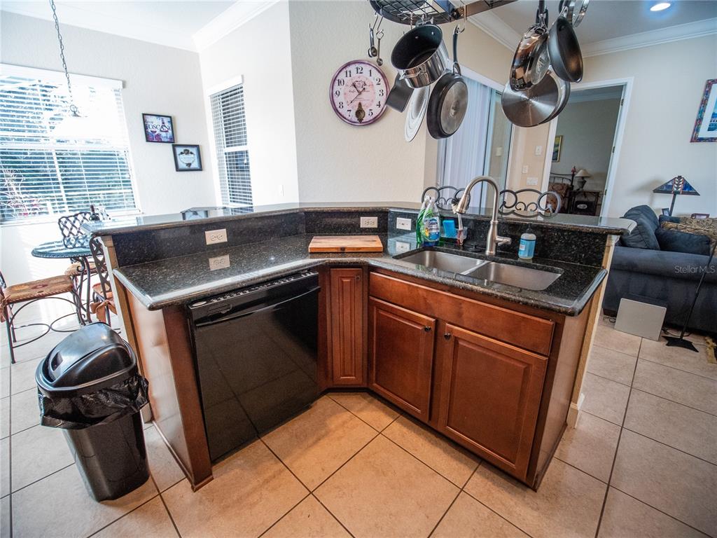 6841 Helmsley Circle Windermere, FL 34786 - Photo 11 of 36 a kitchen with stainless steel appliances granite countertop a sink stove and cabinets