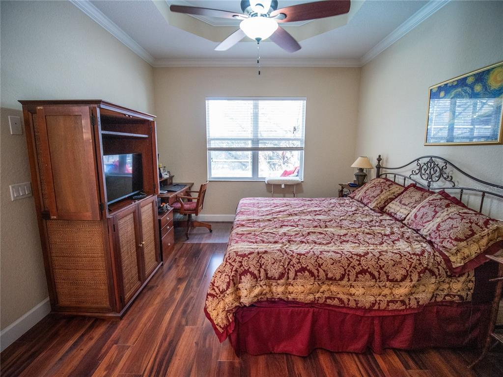 6841 Helmsley Circle Windermere, FL 34786 - Photo 16 of 36 a bedroom with a bed and a flat screen tv