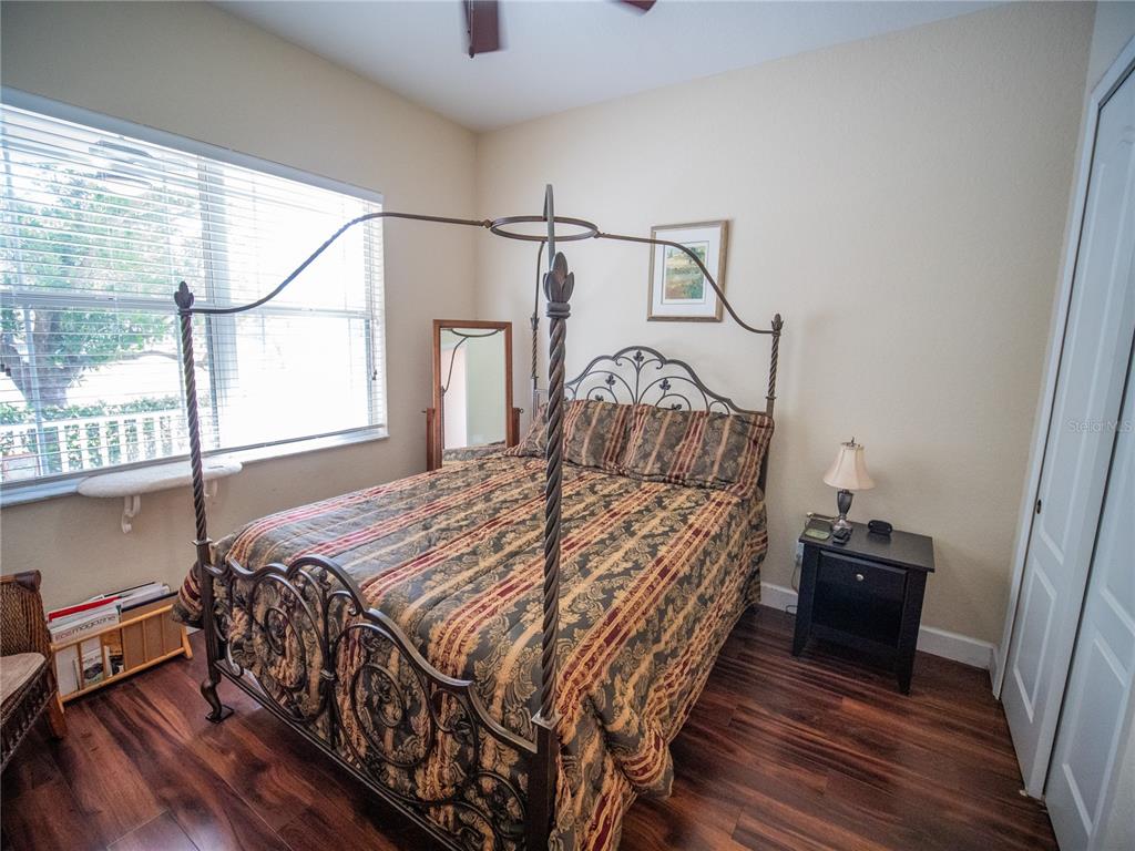 6841 Helmsley Circle Windermere, FL 34786 - Photo 20 of 36 a bedroom with a bed and wooden floor
