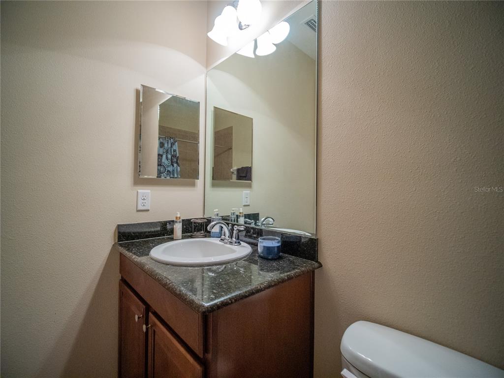 6841 Helmsley Circle Windermere, FL 34786 - Photo 29 of 36 a bathroom with a granite countertop sink and a mirror