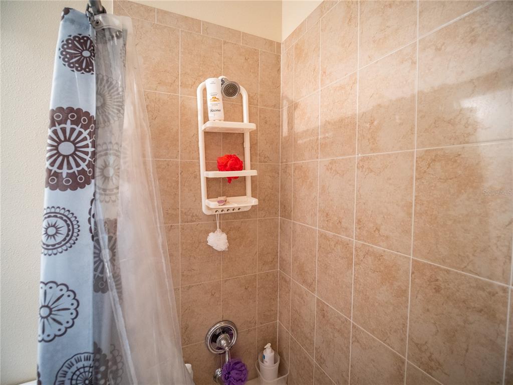 6841 Helmsley Circle Windermere, FL 34786 - Photo 30 of 36 a bathroom with a sink and a shower curtain