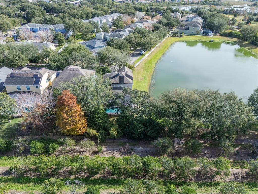 6841 Helmsley Circle Windermere, FL 34786 - Photo 32 of 36 an aerial view of a house with swimming pool and lake view