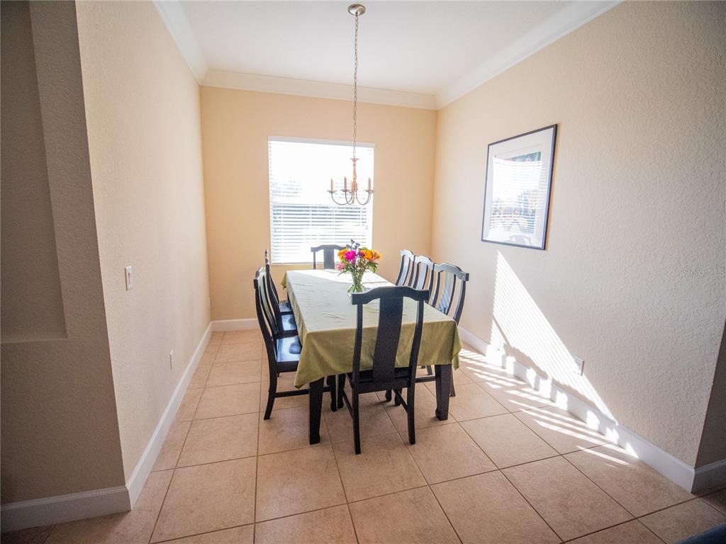 6841 Helmsley Circle Windermere, FL 34786 - Photo 7 of 36 a dining room with furniture and window