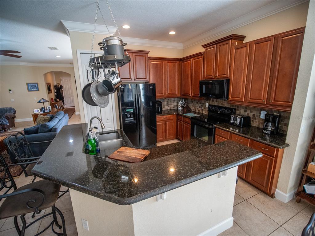 6841 Helmsley Circle Windermere, FL 34786 - Photo 8 of 36 a kitchen with a refrigerator and a sink