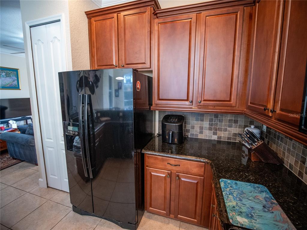 6841 Helmsley Circle Windermere, FL 34786 - Photo 10 of 36 a kitchen with stainless steel appliances granite countertop a refrigerator and a stove top oven