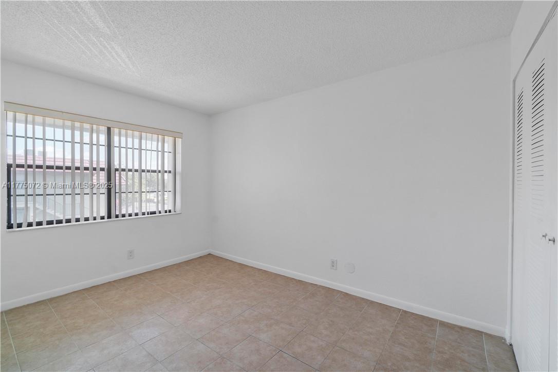3266 Northwest 104th Avenue, Unit 3266 Coral Springs, FL 33065 - Photo 13 of 15 an empty room with a window