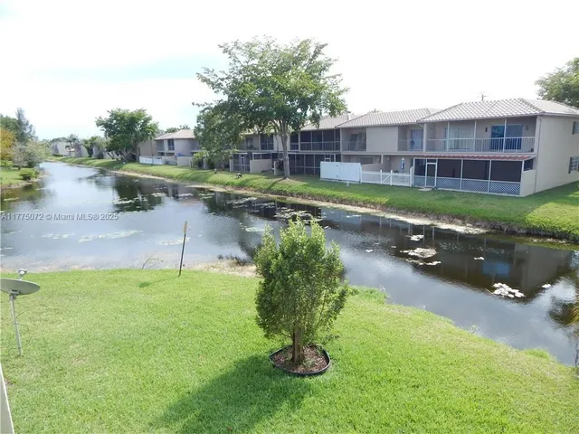 a swimming pool with outdoor seating and yard