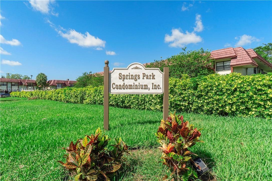 3266 Northwest 104th Avenue, Unit 3266 Coral Springs, FL 33065 - Photo 3 of 15 a sign that is sitting in front of a big yard