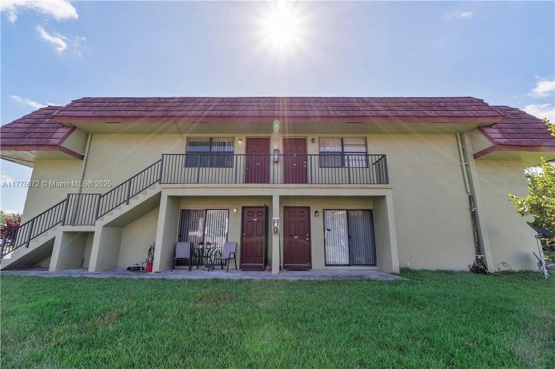 3266 Northwest 104th Avenue, Unit 3266 Coral Springs, FL 33065 - Photo 4 of 15 a view of a brick building with many windows