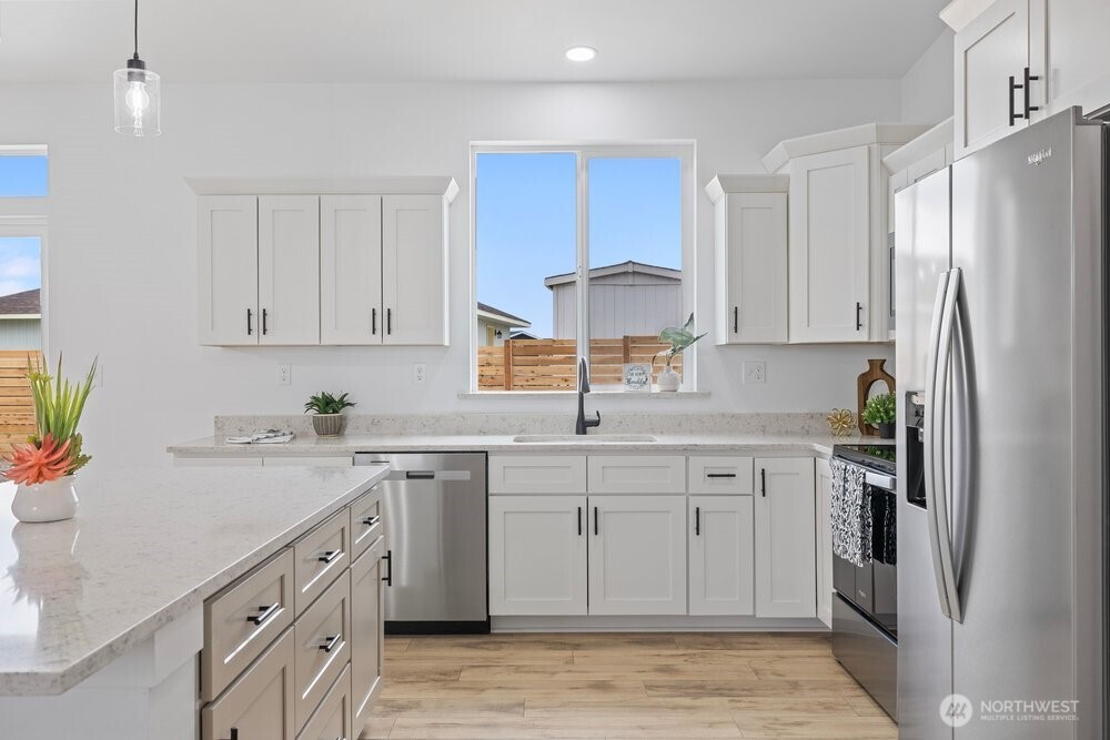 334 Spring Circle Mattawa, WA 99349 - Photo 3 of 40 a kitchen with white cabinets stainless steel appliances and a sink
