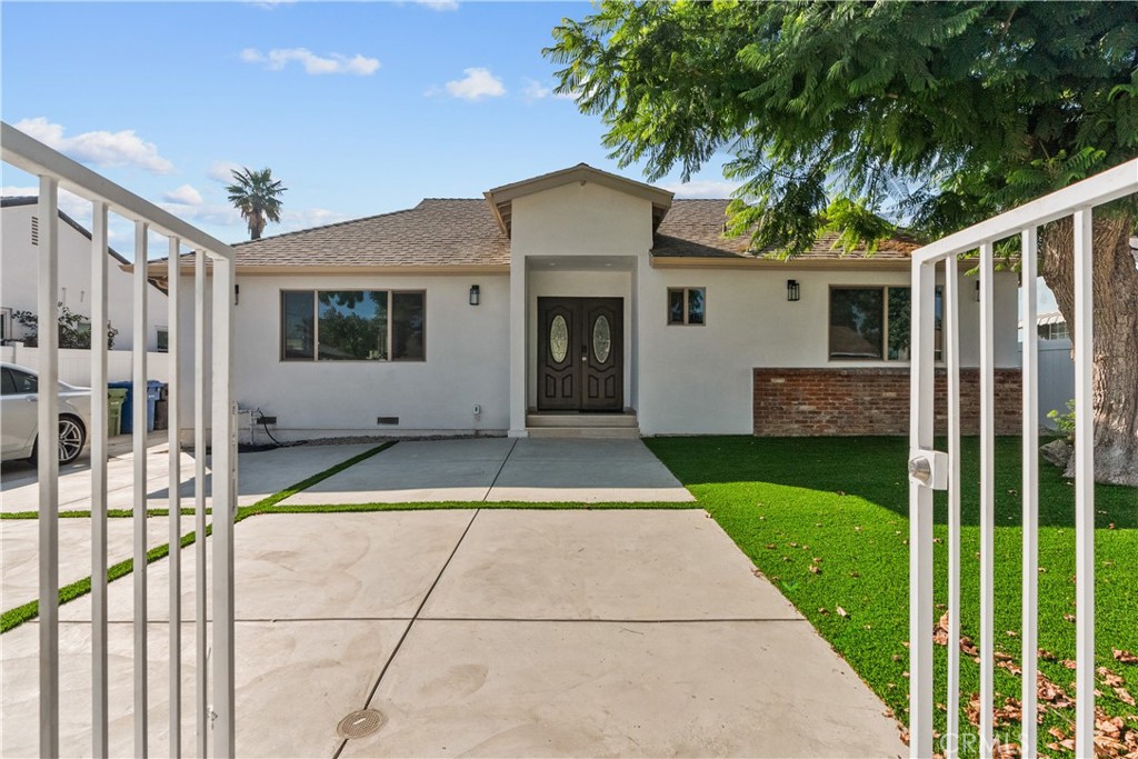 7419 Gloria Avenue Van Nuys, CA 91406 - Photo 1 of 51 a view of a house with a porch and a floor to ceiling window