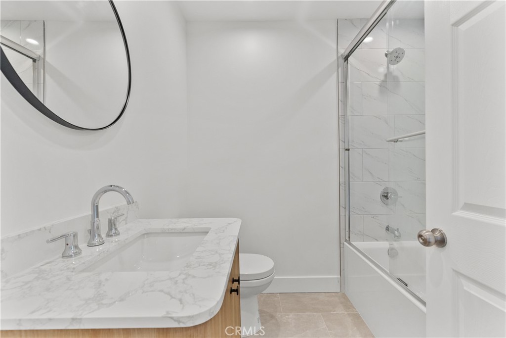 7419 Gloria Avenue Van Nuys, CA 91406 - Photo 18 of 51 a bathroom with a sink a toilet and a mirror