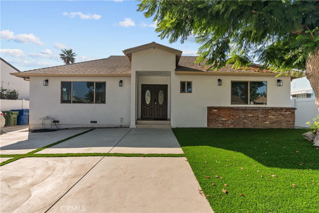 7419 Gloria Avenue Van Nuys, CA 91406 - Photo 2 of 51 a view of a house with a yard and large tree