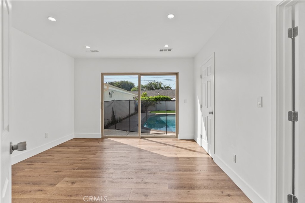 7419 Gloria Avenue Van Nuys, CA 91406 - Photo 24 of 51 a view of an empty room with wooden floor