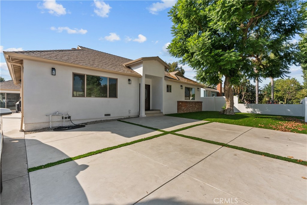 7419 Gloria Avenue Van Nuys, CA 91406 - Photo 3 of 51 a front view of house with yard and trees in the background