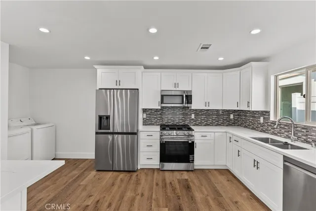 a kitchen with stainless steel appliances granite countertop a stove and a refrigerator
