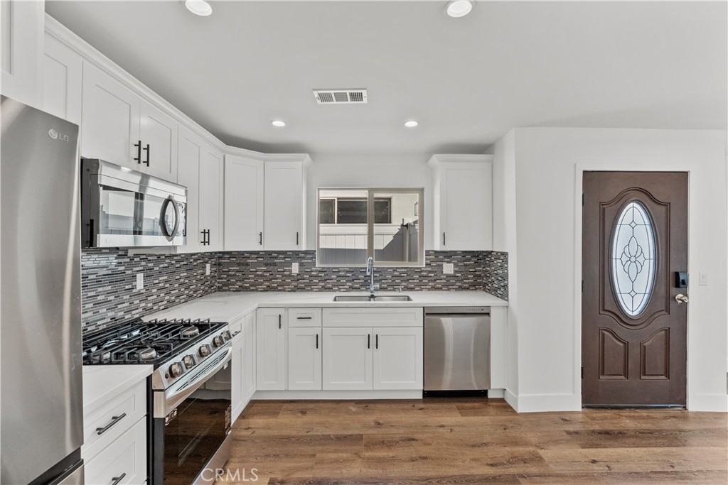 7419 Gloria Avenue Van Nuys, CA 91406 - Photo 39 of 51 a kitchen with stainless steel appliances granite countertop a stove and a refrigerator