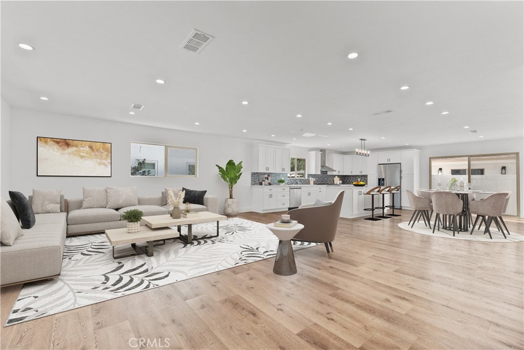 7419 Gloria Avenue Van Nuys, CA 91406 - Photo 4 of 51 a living room with furniture and a table