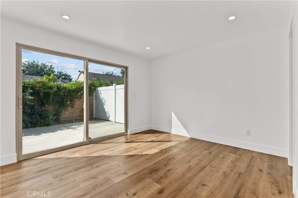7419 Gloria Avenue Van Nuys, CA 91406 - Photo 45 of 51 a view of an empty room with wooden floor and a window