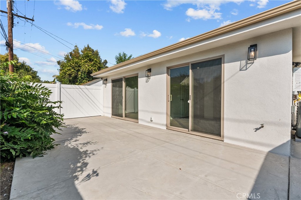 7419 Gloria Avenue Van Nuys, CA 91406 - Photo 49 of 51 a front view of a house with a yard and garage