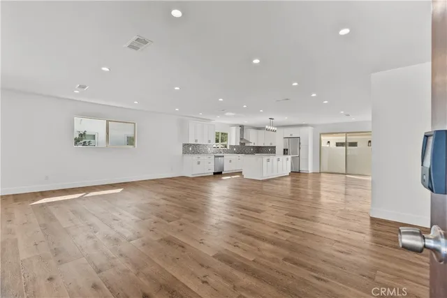 a view of kitchen with kitchen island and stainless steel appliances