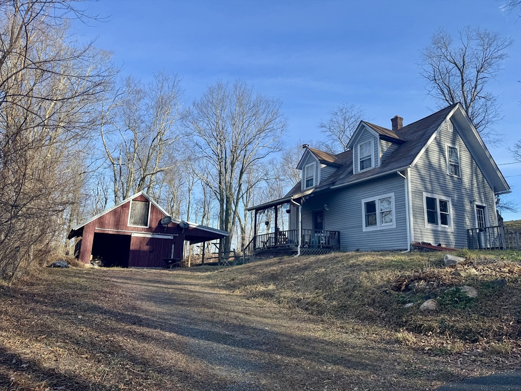 8 Ring Road Worthington, MA 01098 - Photo 1 of 14 a large house with a large tree in front of it