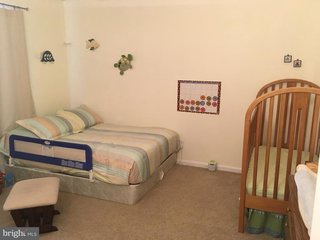 202 Rugby Road Fredericksburg, VA 22406 - Photo 15 of 29 a bedroom with a bed and chair