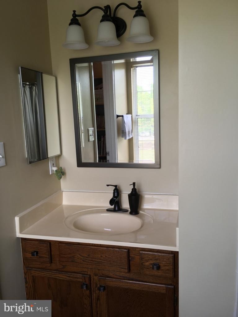 202 Rugby Road Fredericksburg, VA 22406 - Photo 19 of 29 a bathroom with a sink and a mirror