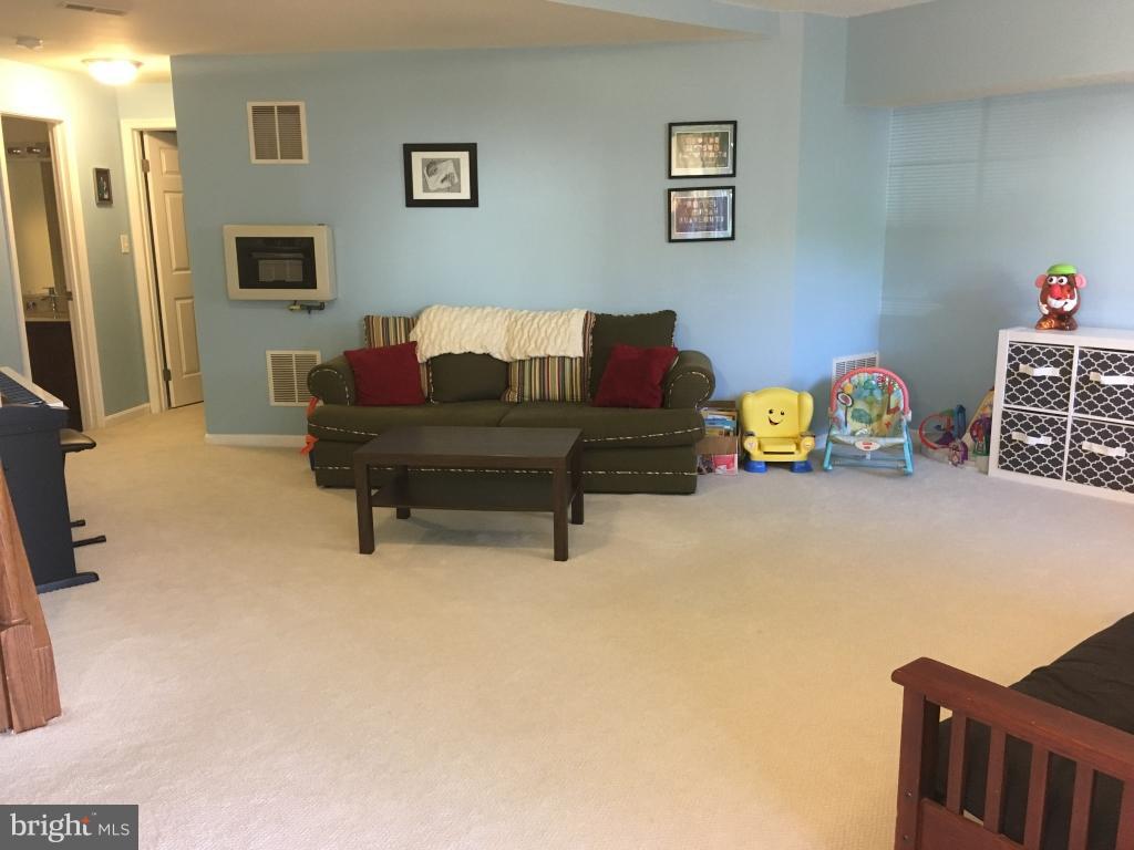 202 Rugby Road Fredericksburg, VA 22406 - Photo 24 of 29 a living room with furniture and a flat screen tv