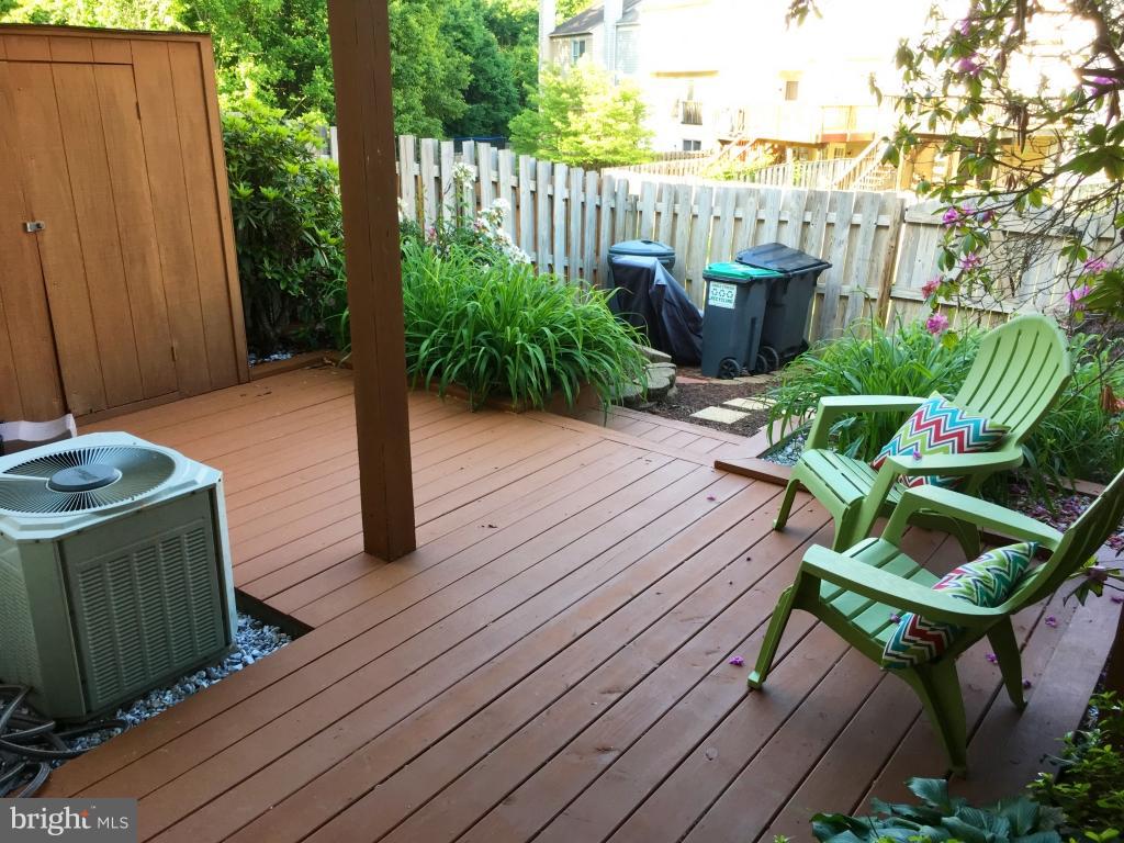 202 Rugby Road Fredericksburg, VA 22406 - Photo 26 of 29 a backyard of a house with wooden floor chairs and plants