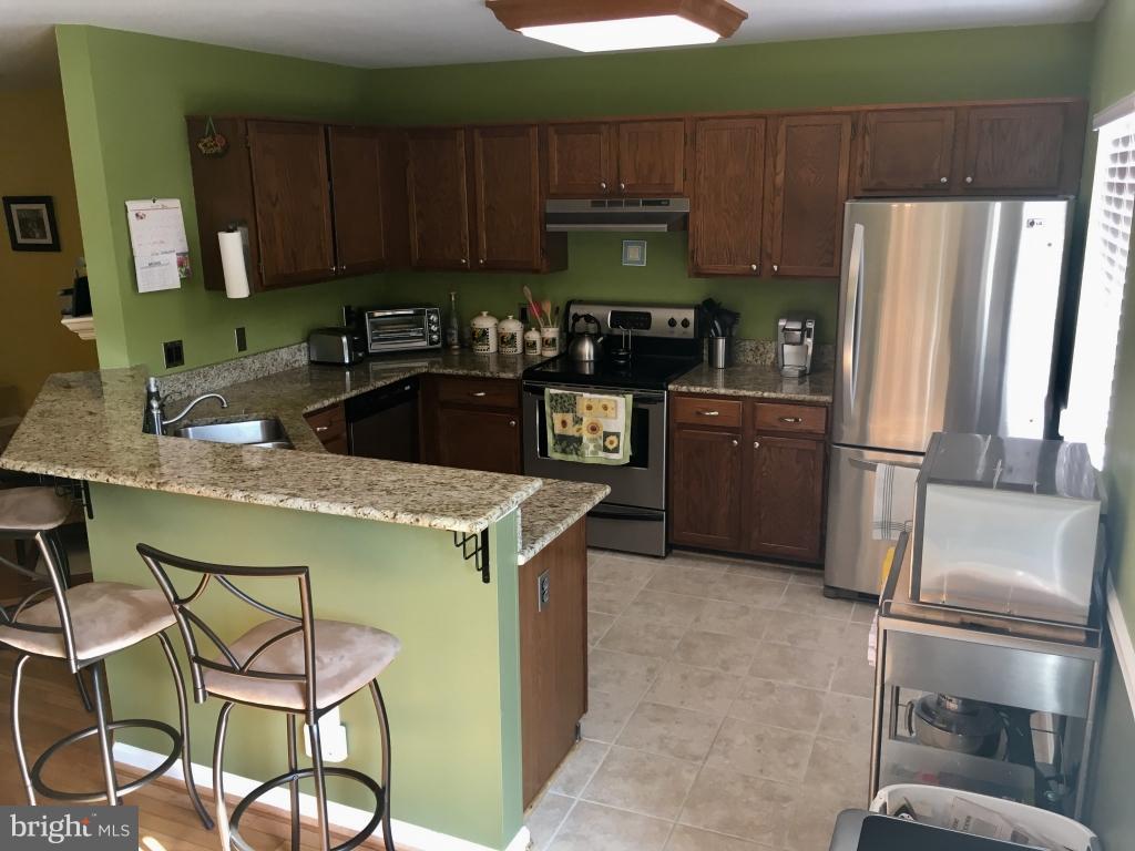 202 Rugby Road Fredericksburg, VA 22406 - Photo 5 of 29 a kitchen with a refrigerator and a sink