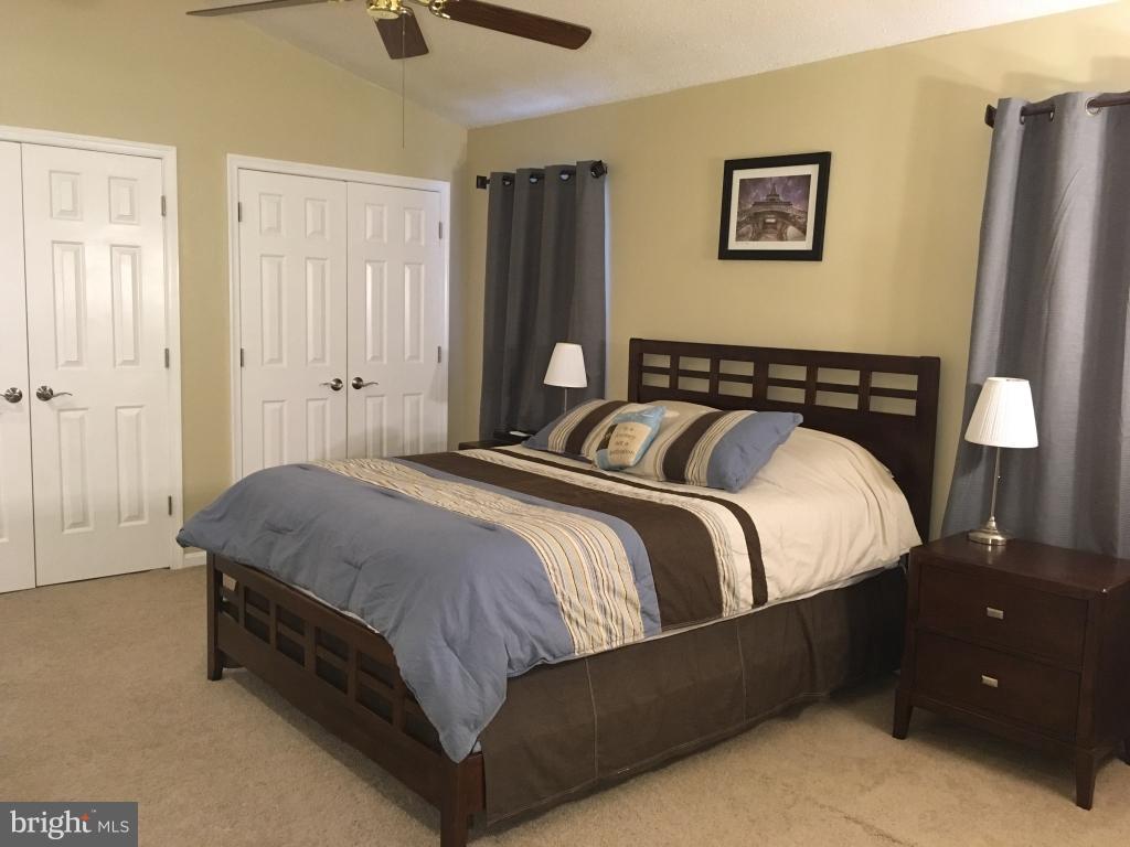 202 Rugby Road Fredericksburg, VA 22406 - Photo 9 of 29 a spacious bedroom with a bed and wooden floor