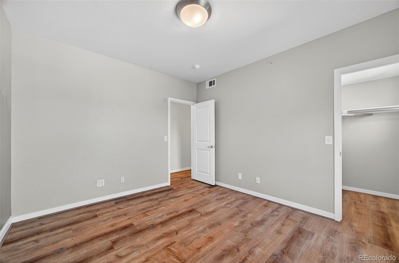 2389 South High Street, Unit 4 Denver, CO 80210 - Photo 13 of 32 a view of a room with wooden floor and white walls