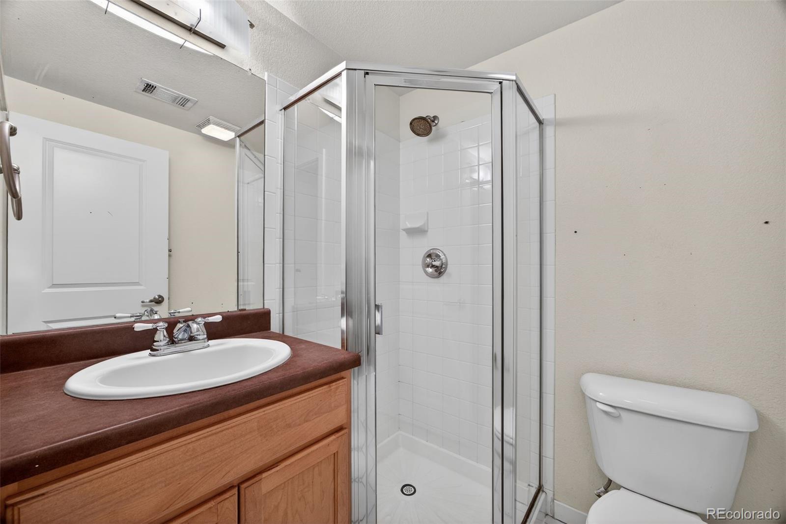 2389 South High Street, Unit 4 Denver, CO 80210 - Photo 15 of 32 a bathroom with a sink toilet and shower