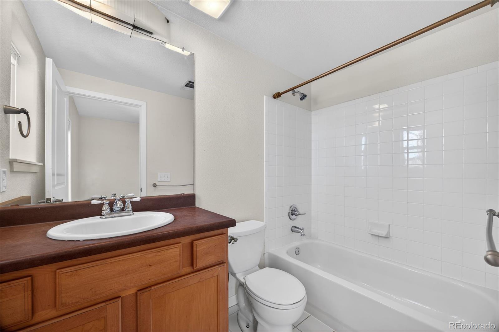 2389 South High Street, Unit 4 Denver, CO 80210 - Photo 20 of 32 a bathroom with a granite countertop sink toilet and shower
