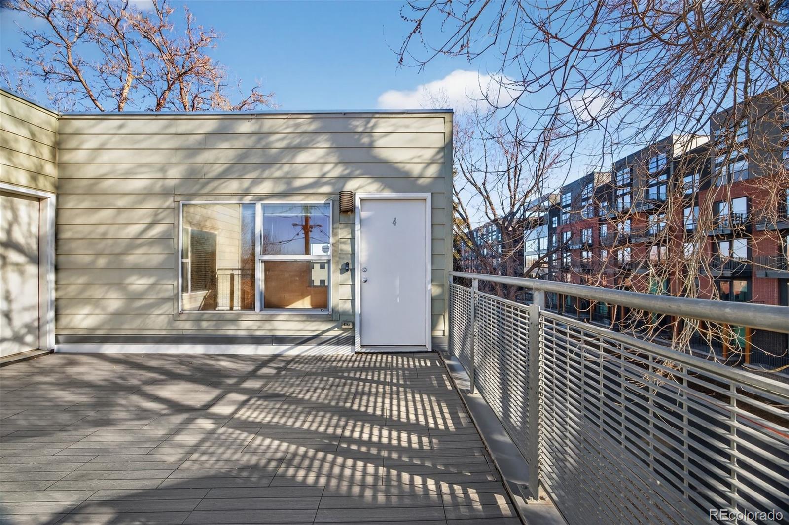 2389 South High Street, Unit 4 Denver, CO 80210 - Photo 25 of 32 a view of a balcony with wooden floor and fence