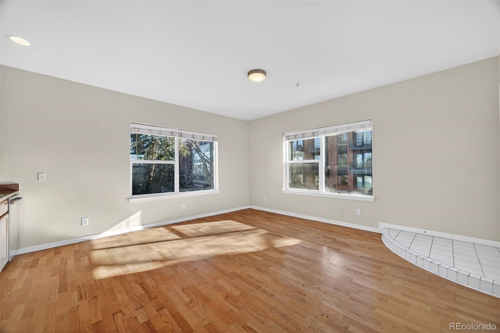 2389 South High Street, Unit 4 Denver, CO 80210 - Photo 8 of 32 a view of an empty room with a window