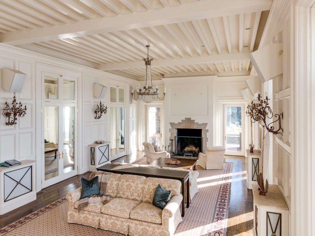 71 Eastern Point Boulevard Gloucester, MA 01930 - Photo 19 of 40 a living room with furniture a fireplace and a chandelier